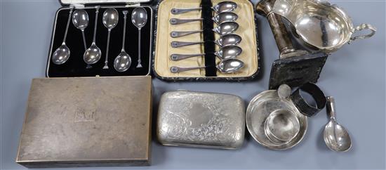 A silver cigarette case, silver cigarette box, silver sauceboat, silver candlestick, silver caddy spoon etc.